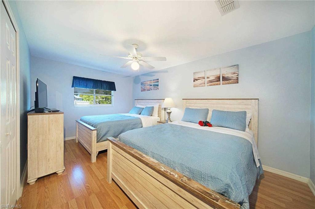 The second guest bedroom offers 2 queen-size beds & flat-screen TV