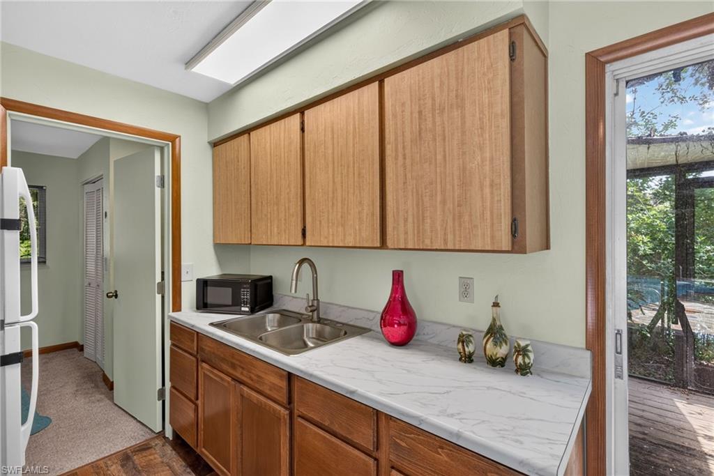 Kitchen with cabinetry and refrigerator.