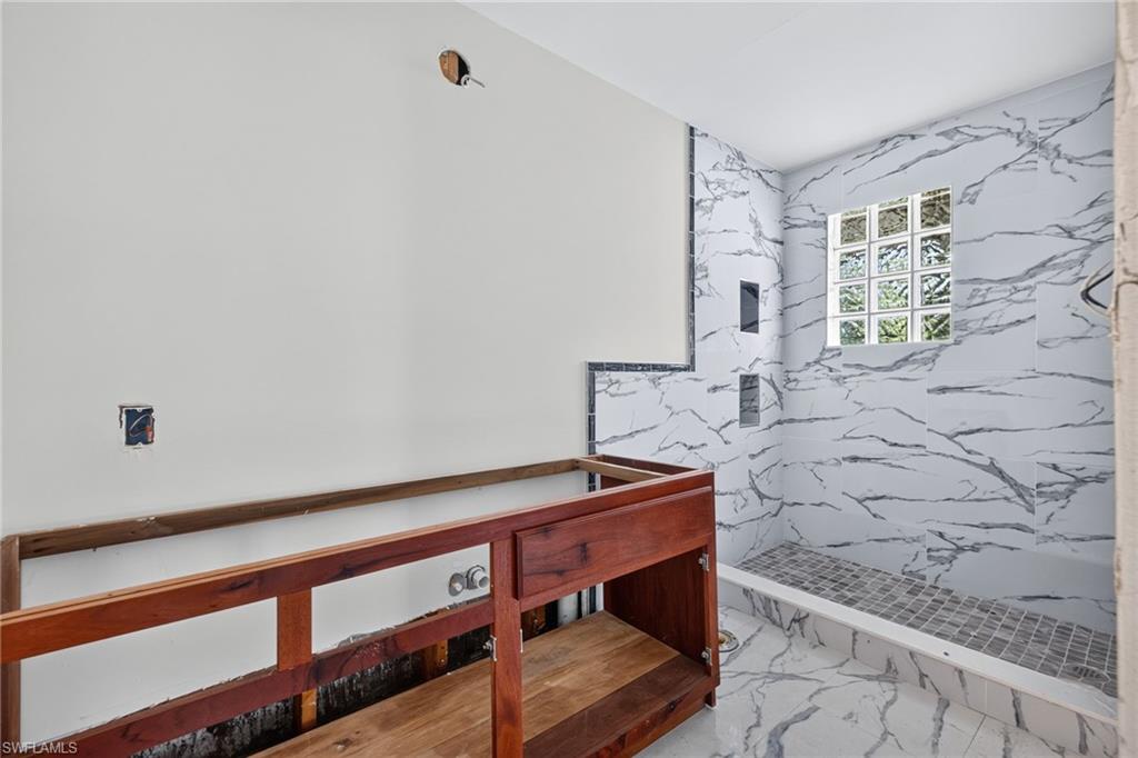 Third bedroom with two windows, one overlooking the waterfall