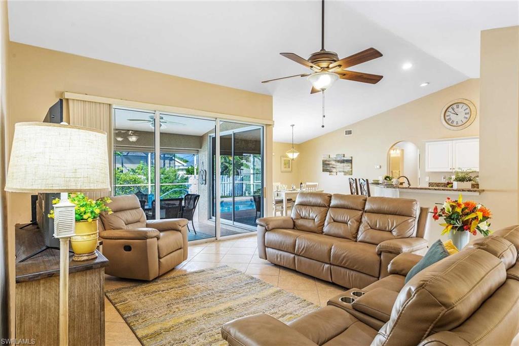 The living room has recliners and a flat-screen TV