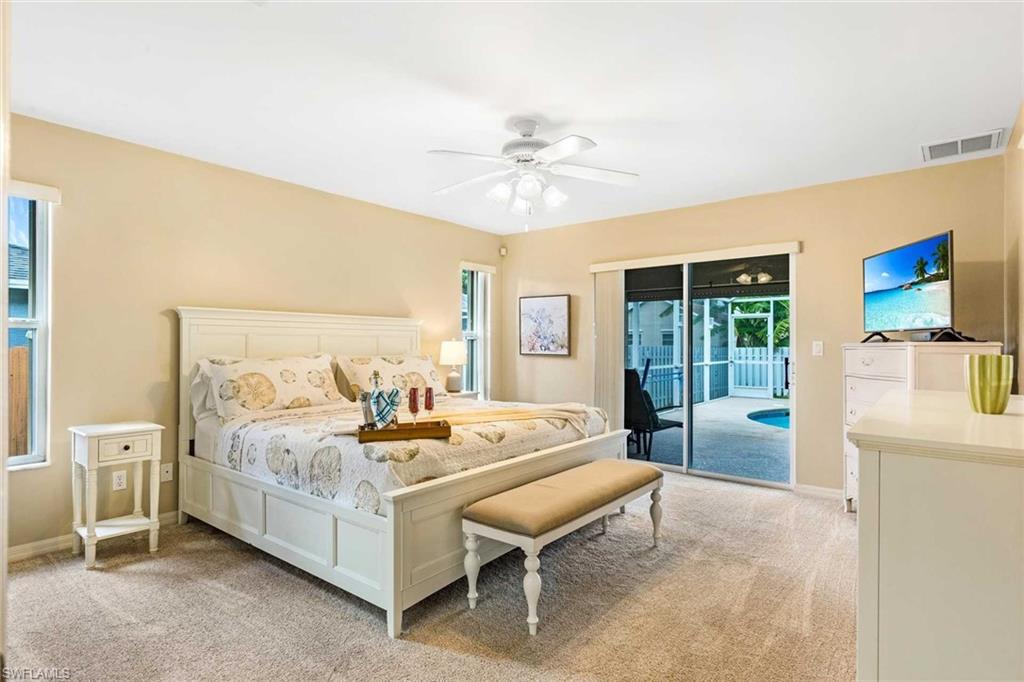 The primary bedroom offers a King bed, sliders to the pool & a flat-screen TV