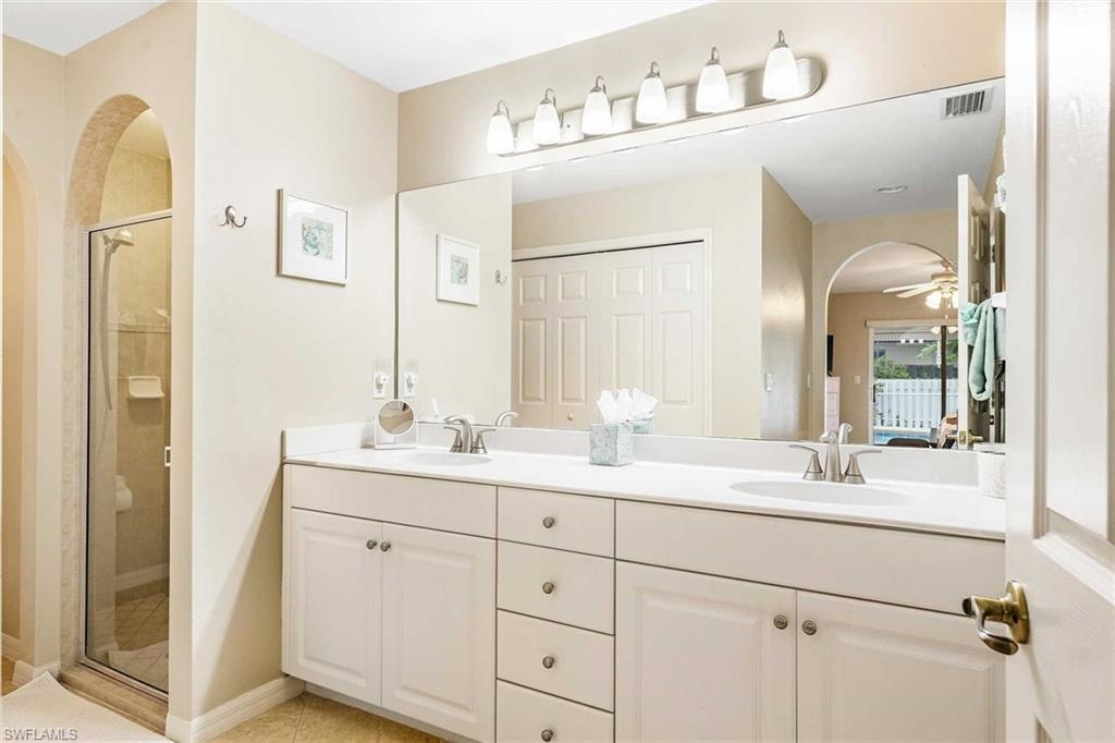 The primary bathroom has a double-sink vanity and a walk-in shower