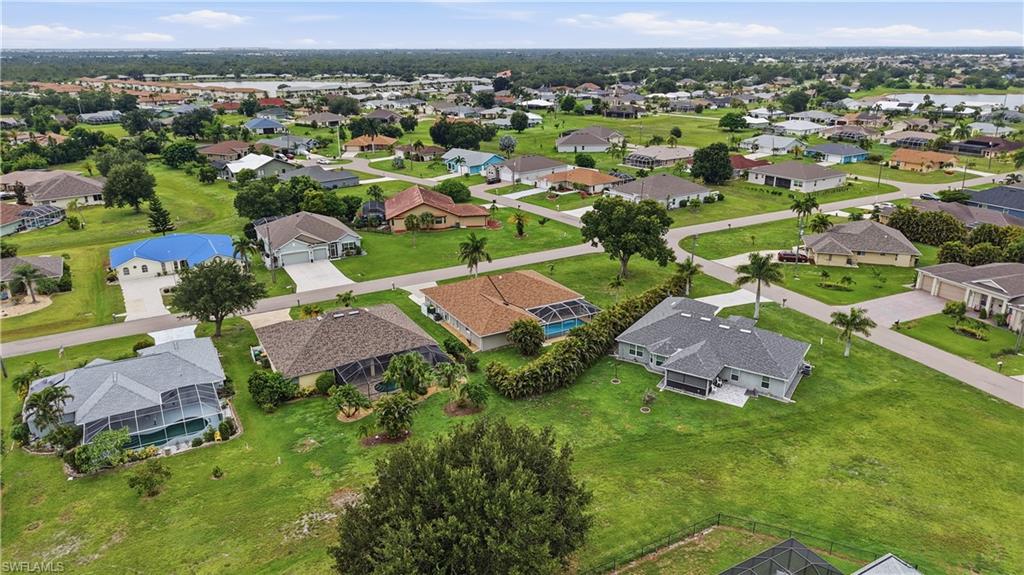 Expansive residential community featuring a variety of single-story homes with diverse architectural styles, screened pool enclosures, and mature landscaping