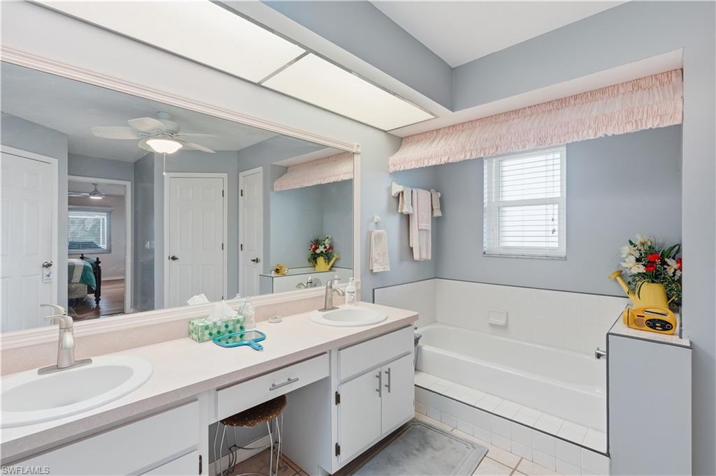 Dual vanity with undermount sinks and brushed nickel faucets set in a light countertop