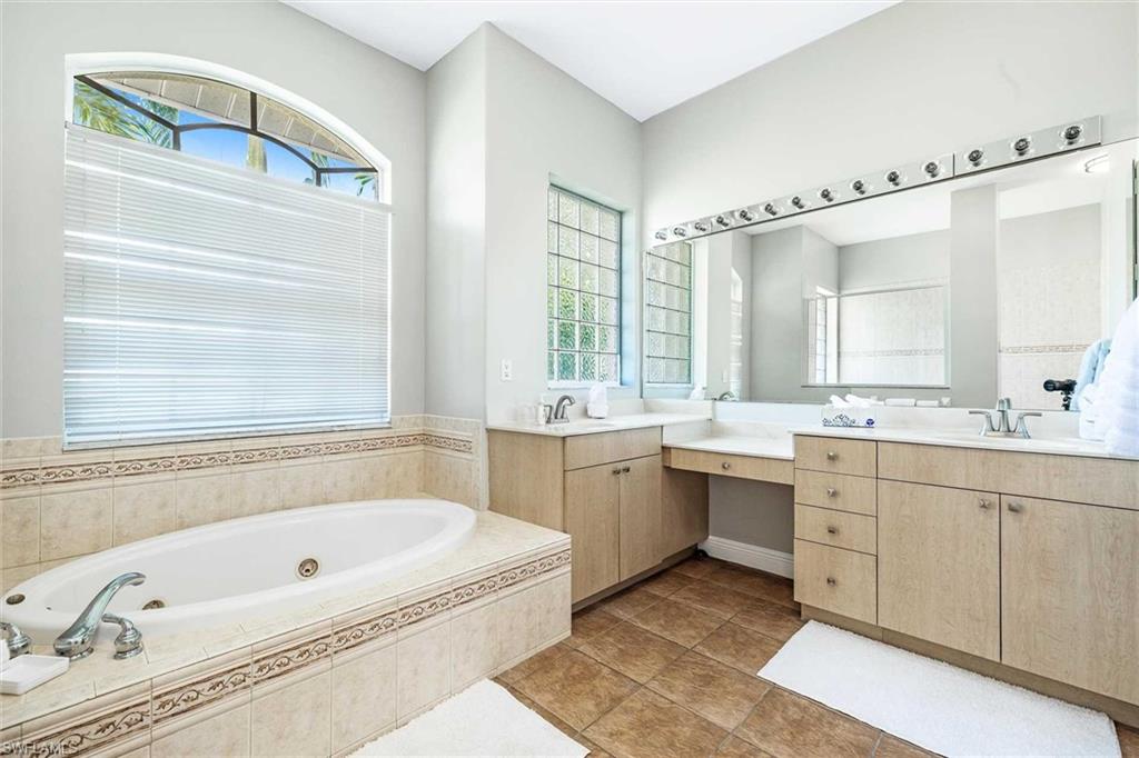 There are two sinks and a sitting vanity area