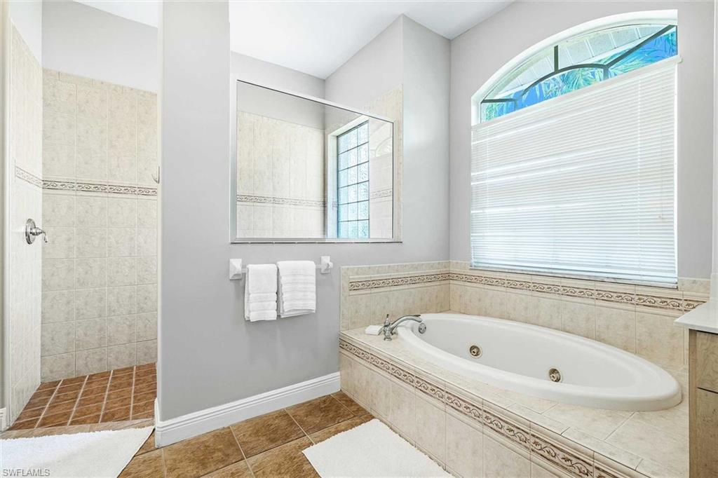 The primary bathroom has an oversized walk-in closet & jetted tub