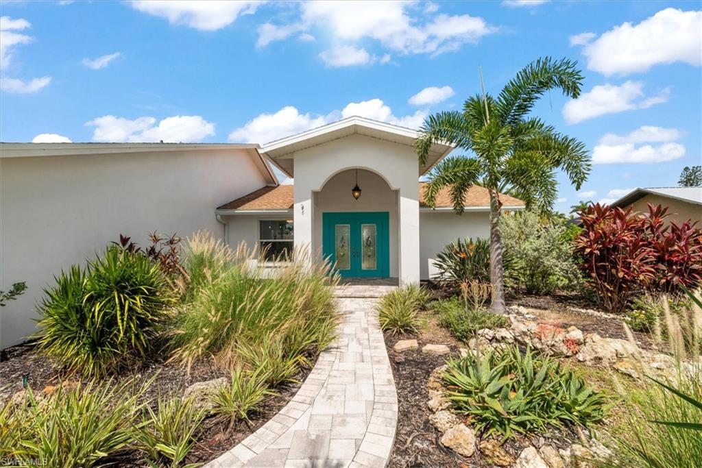 Property entrance with stucco siding, french doors, and roof with shingles