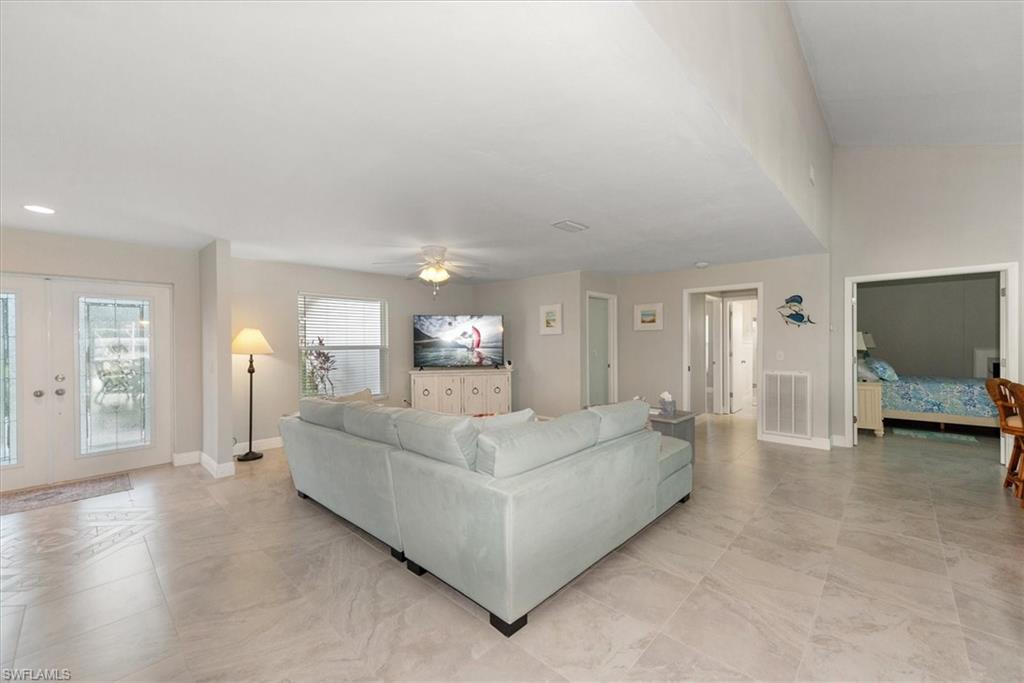 Living room with ceiling fan and french doors