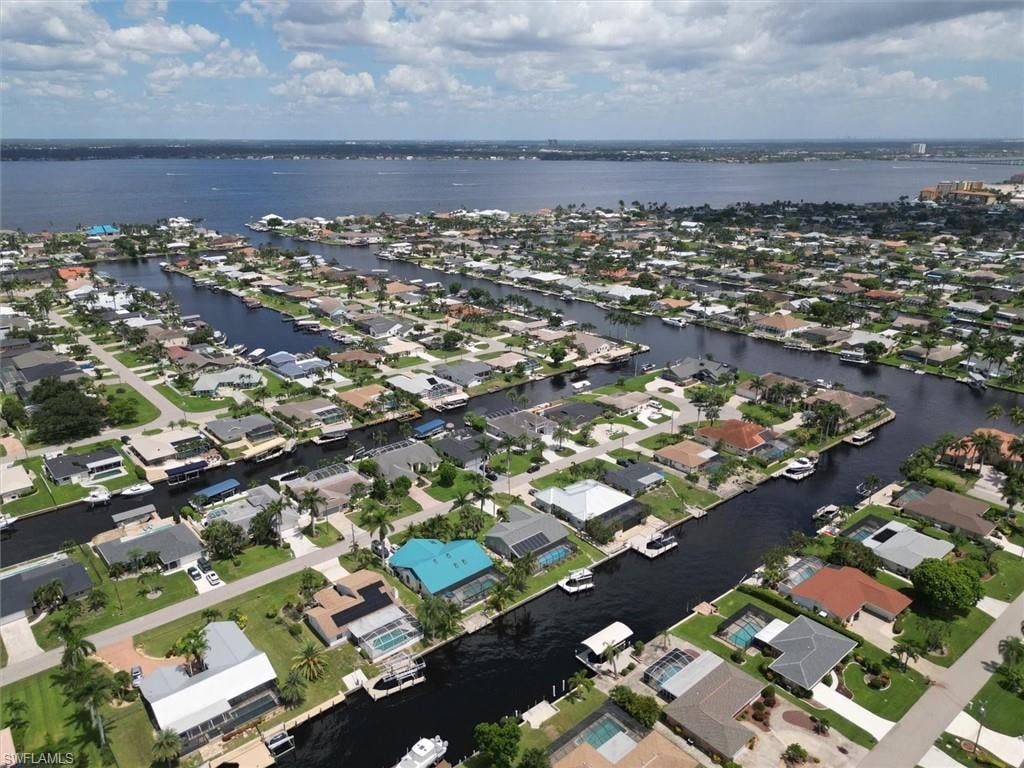 Aerial overview of property's location featuring nearby suburban area and a large body of water
