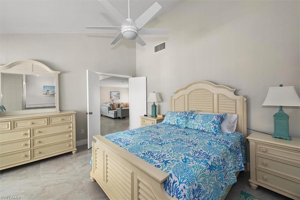 Bedroom featuring high vaulted ceiling and ceiling fan