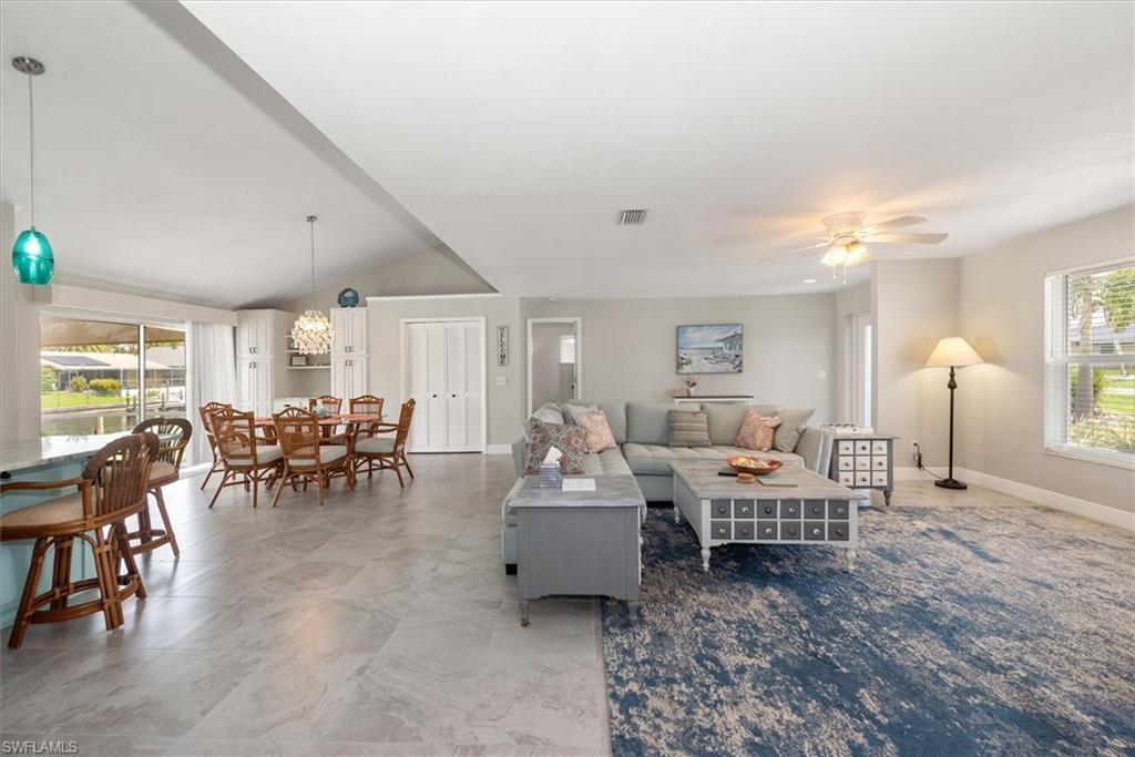 Living area with ceiling fan and lofted ceiling