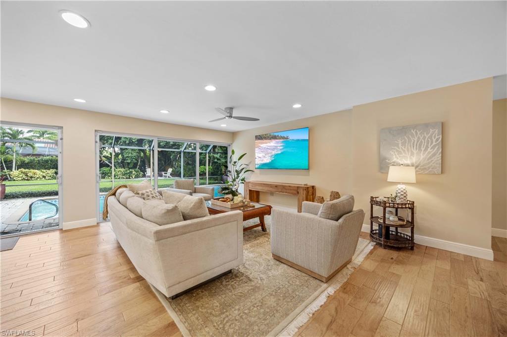 Living room featuring ceiling fan and light wood-type flooring