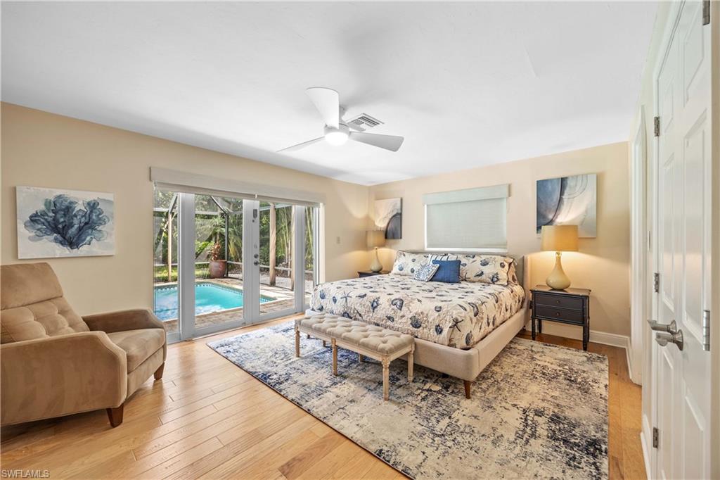 Bedroom with ceiling fan, light wood-type flooring, french doors, and access to outside