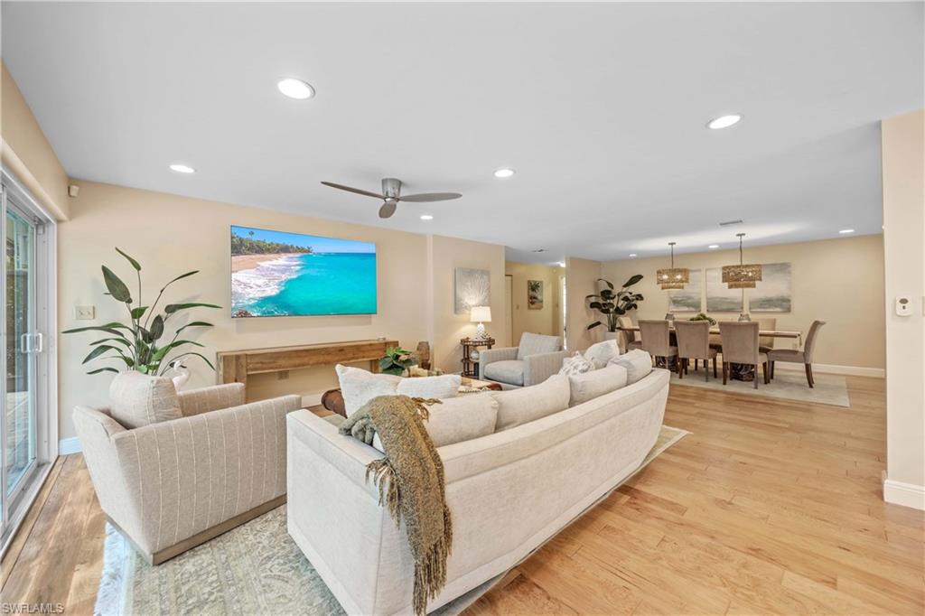 Living room with ceiling fan and light wood-type flooring