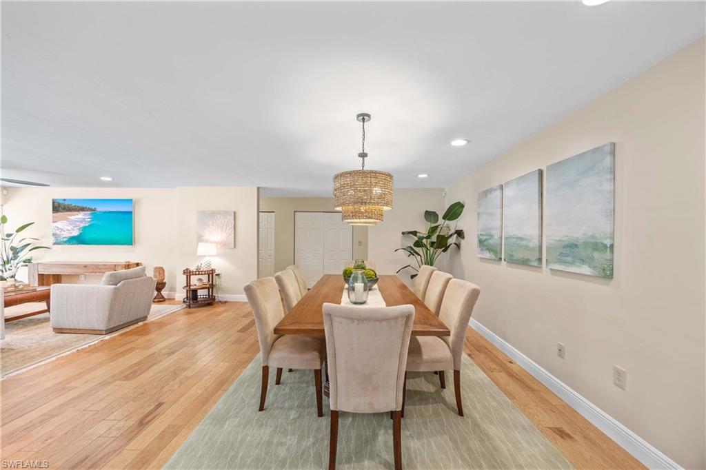 Dining room with a notable chandelier and light hardwood / wood-style floors