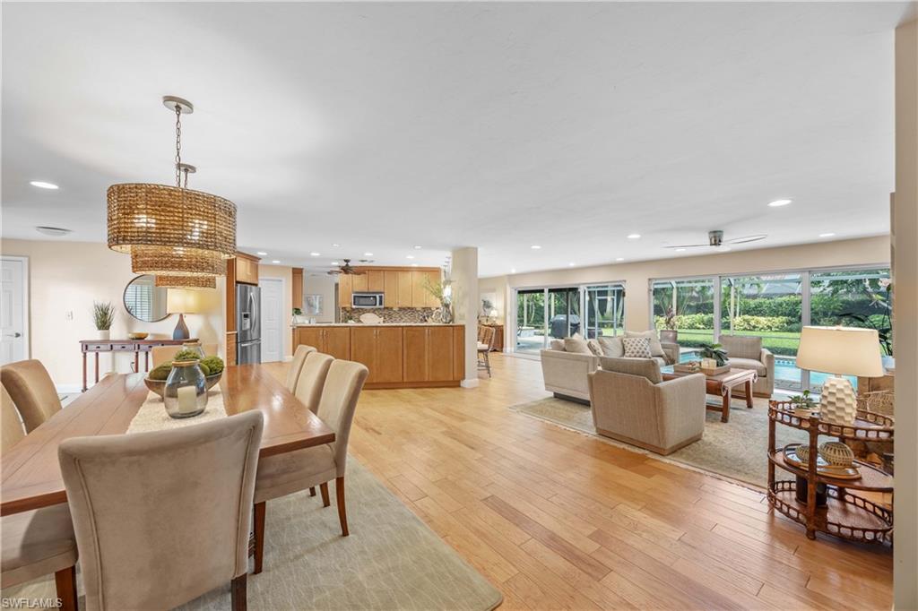 Dining room with ceiling fan and light hardwood / wood-style floors