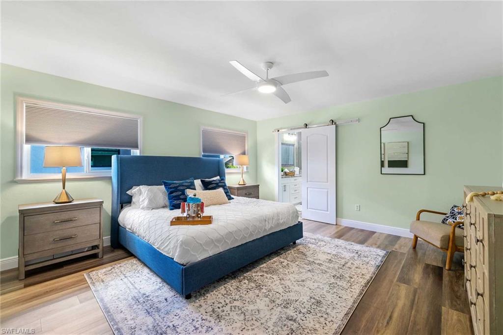 The spacious primary suite has a king-size bed with flat-screen TV