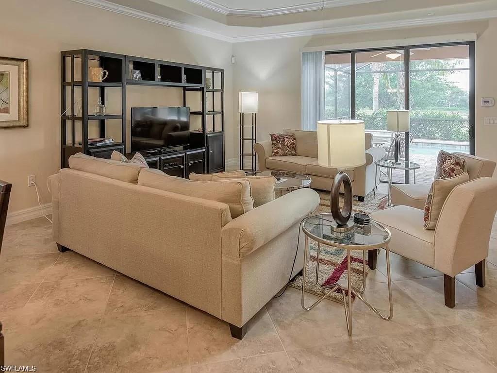 Living room featuring ornamental molding and light tile patterned floors