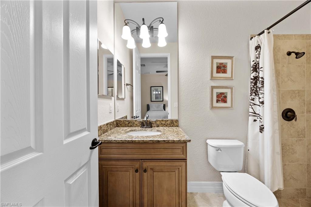 Bathroom with tile floors, vanity, and toilet