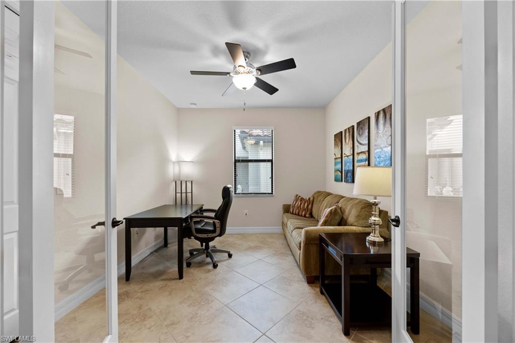 Office featuring ceiling fan and light tile floors
