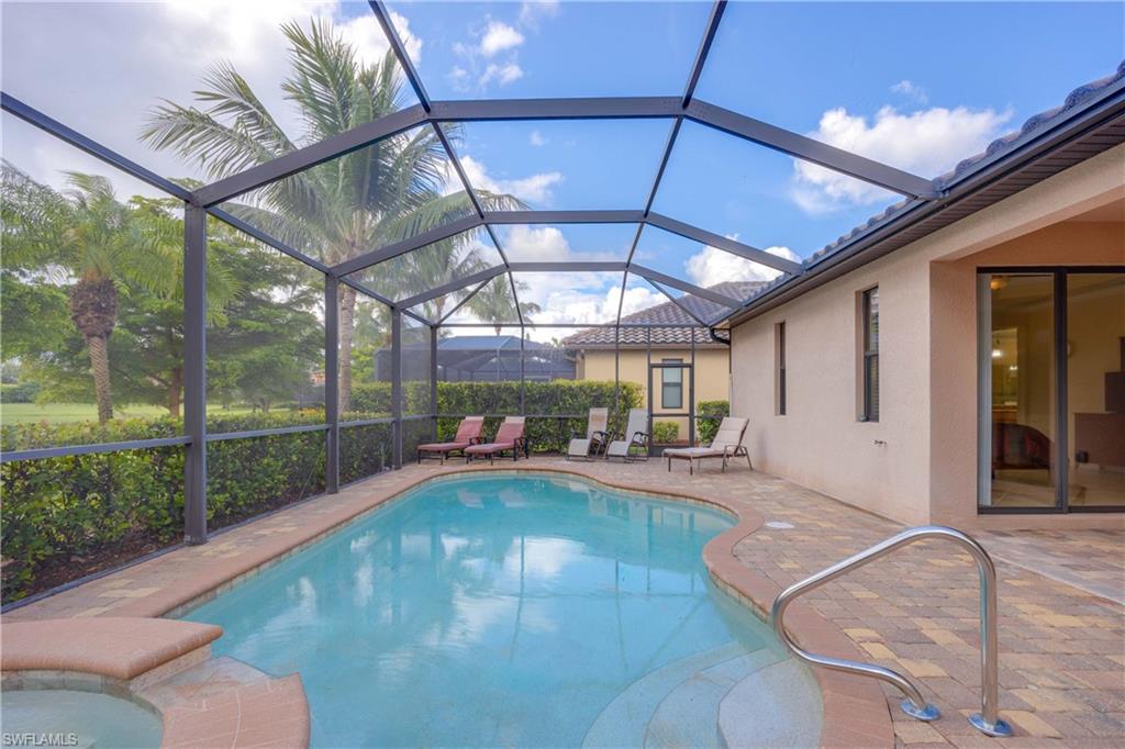 View of pool with a lanai and a patio area