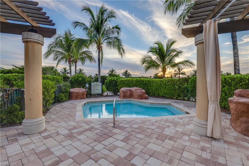 Pool at dusk featuring a pergola and a patio