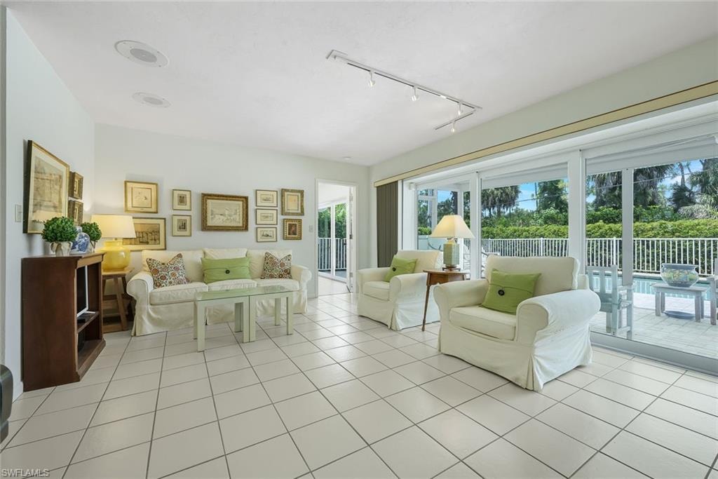 Living room offers gorgeous pool views.