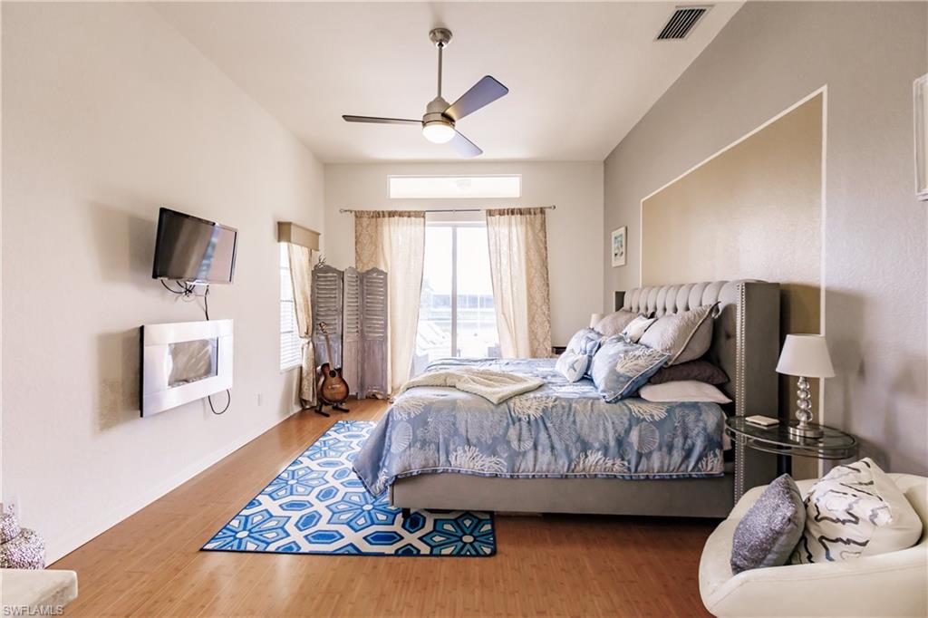 Bedroom with ceiling fan and wood-type flooring
