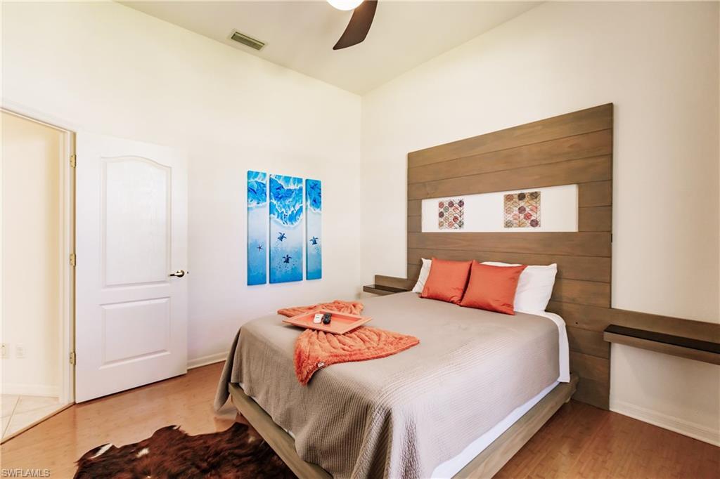Bedroom with ceiling fan and hardwood / wood-style flooring
