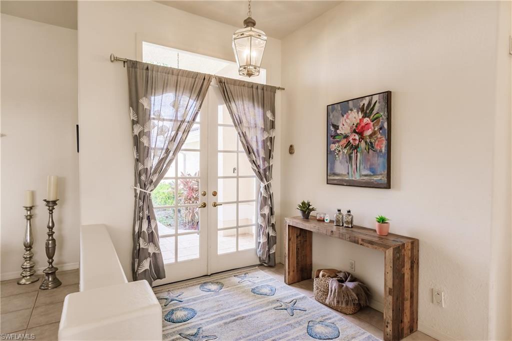 Doorway to outside featuring french doors and light tile patterned flooring