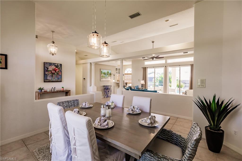 Tiled dining space featuring ceiling fan
