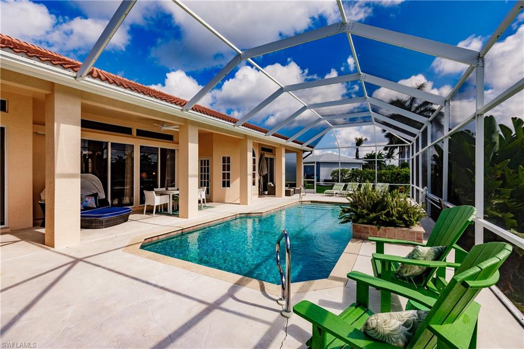 View of swimming pool featuring a lanai, ceiling fan, and a patio