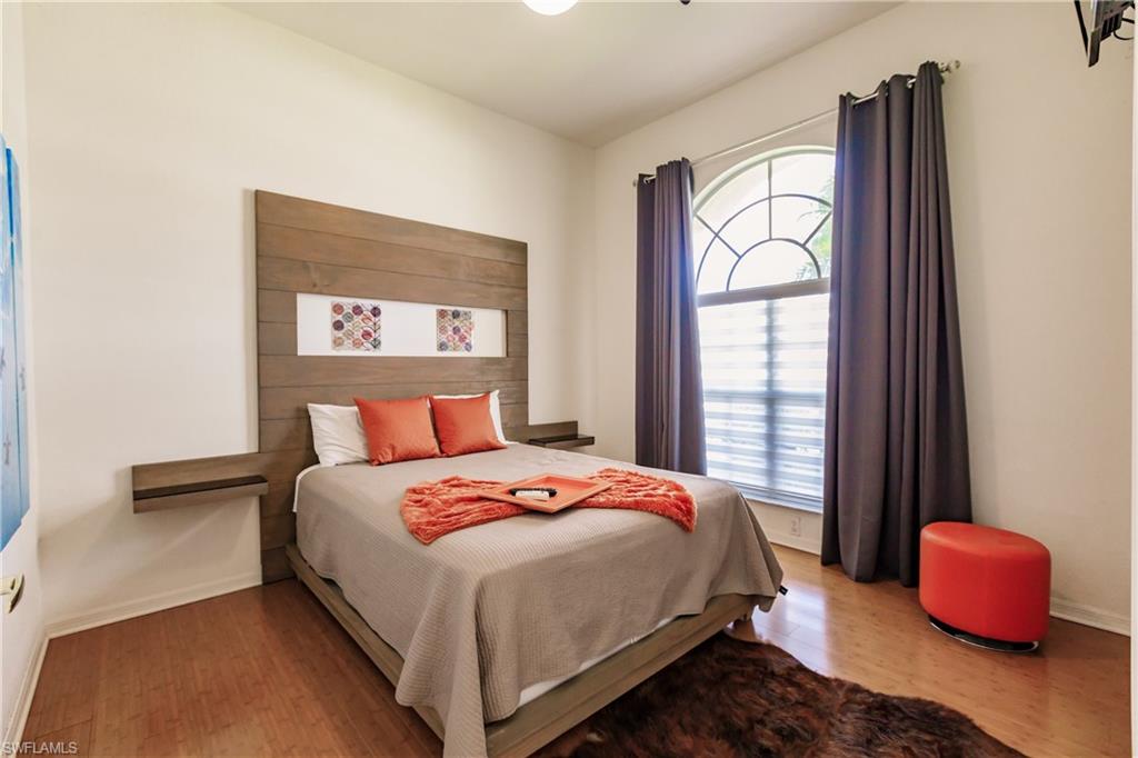 Bedroom with hardwood / wood-style flooring