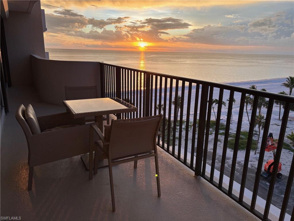 Balcony at dusk featuring a water view