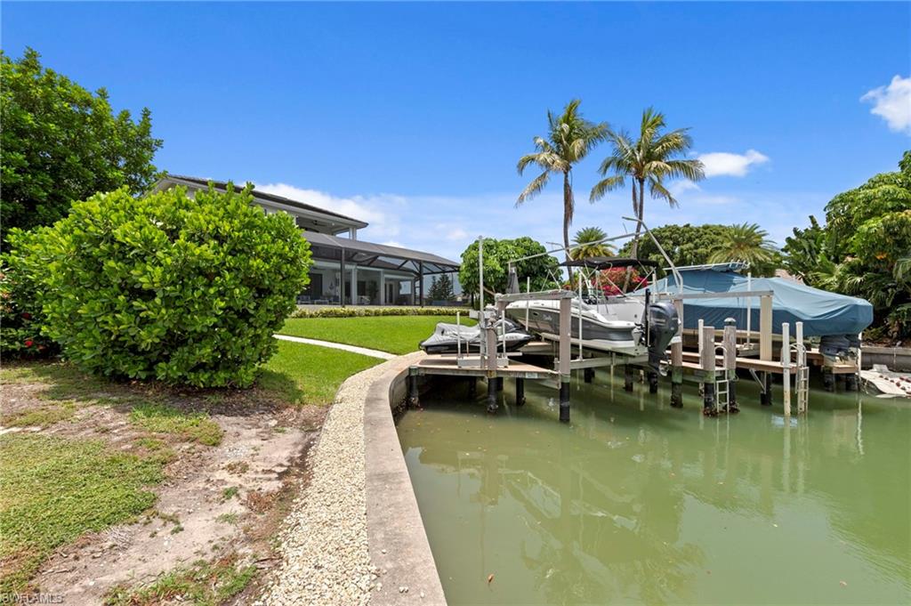 Private dock featuring two boat lifts