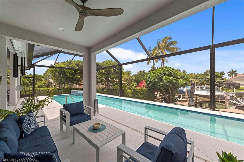 Screened lanai featuring a swimming pool, covered patio, and water access with a boat lift