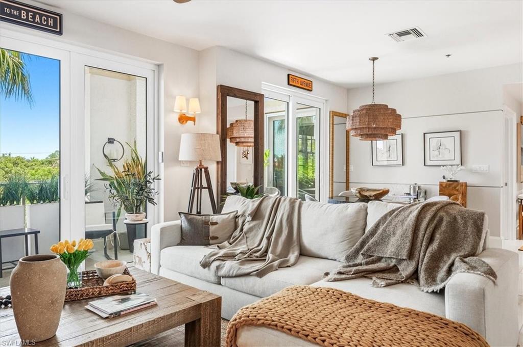 Bright living area featuring a large sliding glass door opening to an outdoor balcony