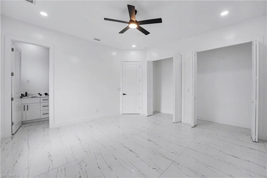 Spacious interior room featuring large format tile flooring, a ceiling fan with integrated lighting, and recessed ceiling lights