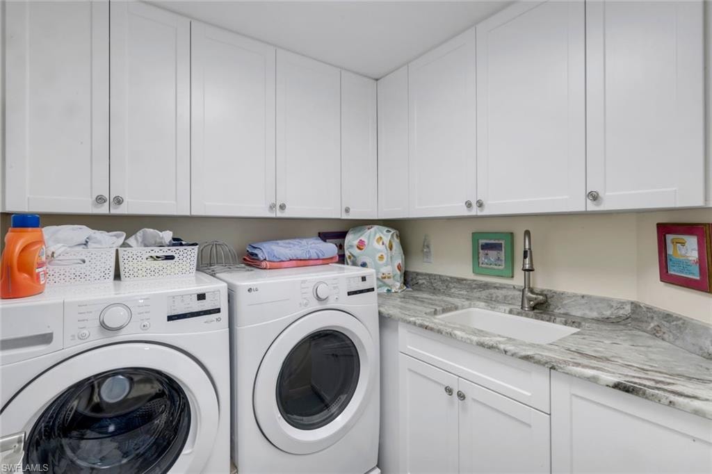 Remodeled laundry room with wrap around cabinets and stunning stone countertop