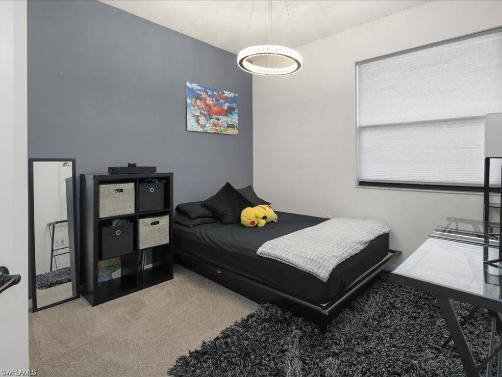 Neutral-toned carpet flooring complements the accent wall