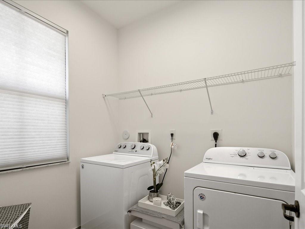 Dedicated utility room featuring light-toned walls and hard-surface flooring