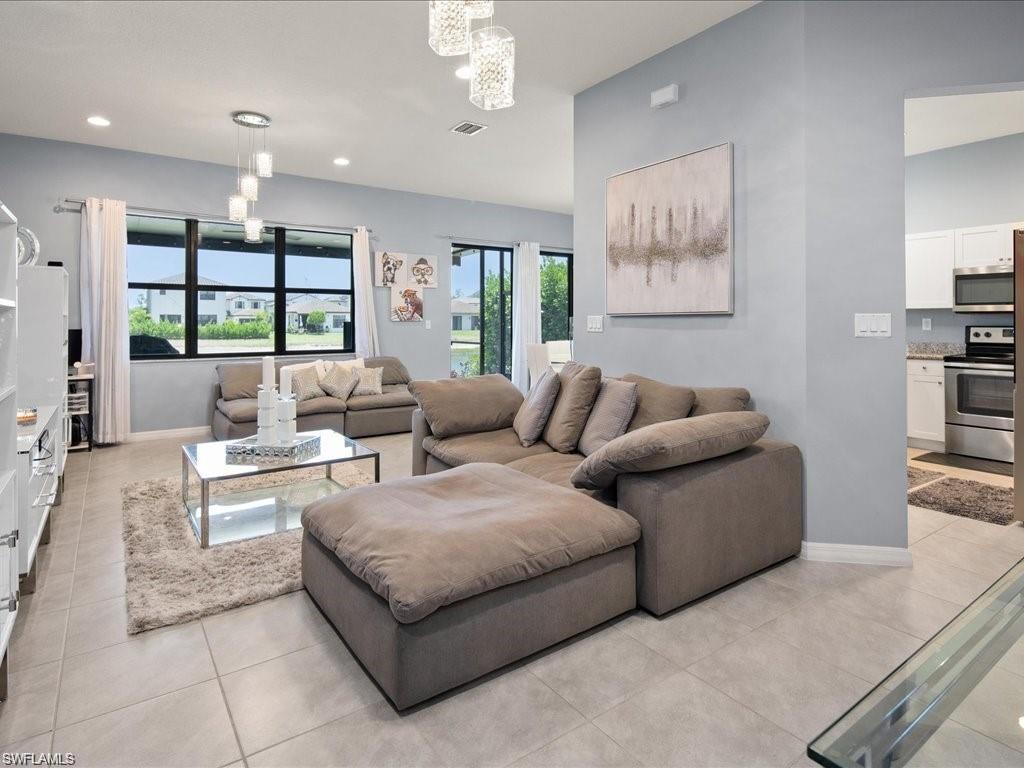 Expansive living area featuring large format tile flooring and multiple windows providing ample natural light