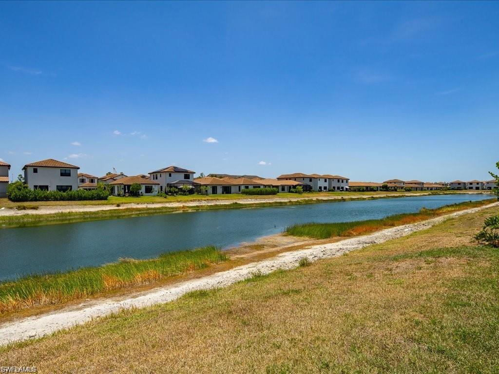 Waterfront property featuring a canal and homes with tile roofs