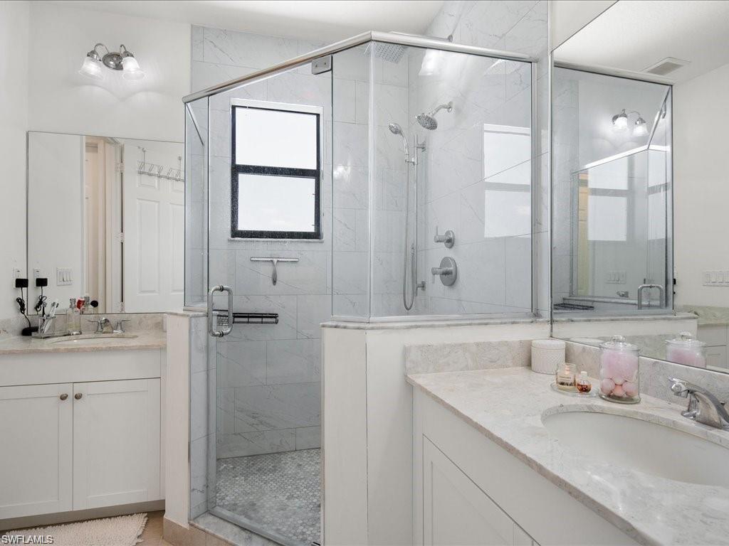 Glass-enclosed shower with a tiled interior and window
