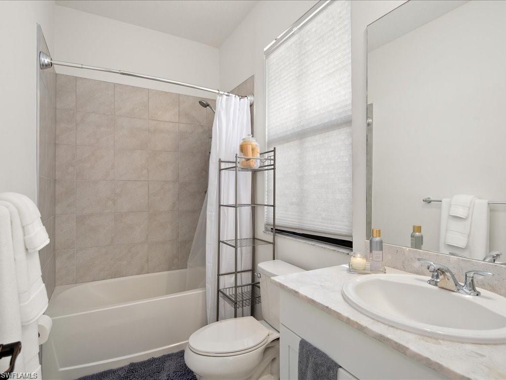 Bathroom featuring a tub and shower combination with tiled surround