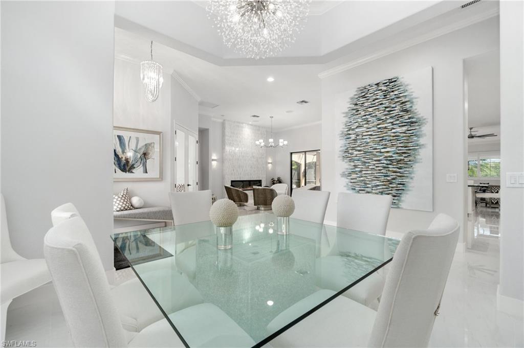 Dining area with a coffered ceiling and a contemporary chandelier