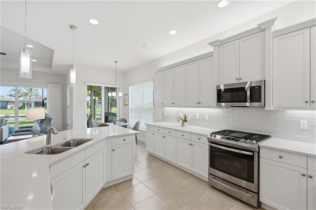 Gourmet kitchen with quartz countertops and white cabinetry.