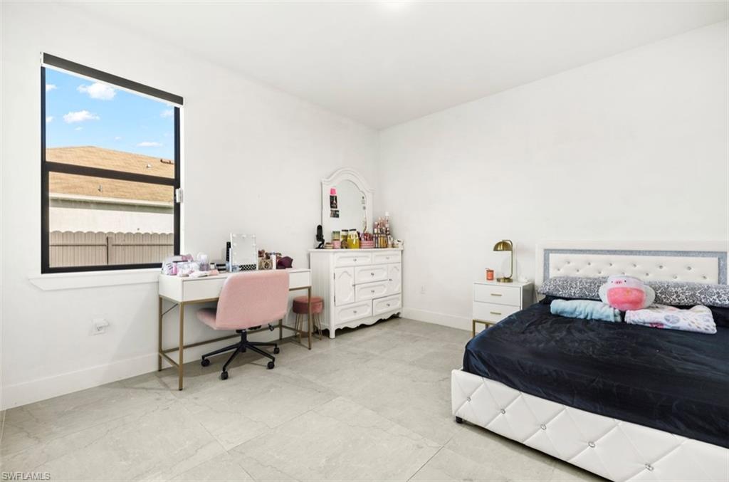 Bright interior space featuring light-toned tile flooring and white painted walls
