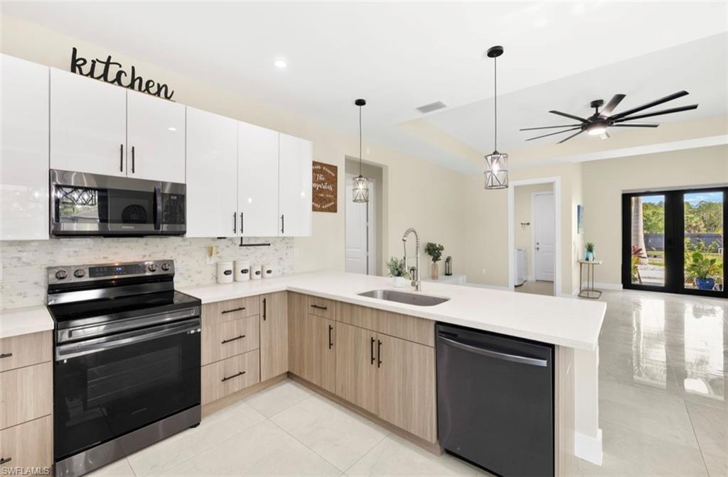 Contemporary kitchen featuring a stainless steel microwave, electric range, and dishwasher