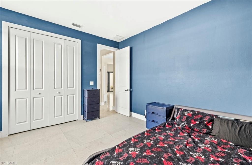 Room with light tile flooring, white baseboards, and a white ceiling